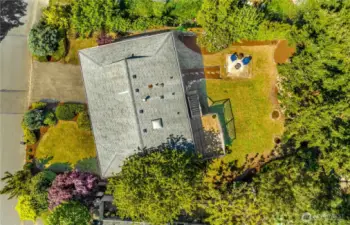 This bird's eye view of the property shows off the mature landscaping all around, and the spacious backyard.
