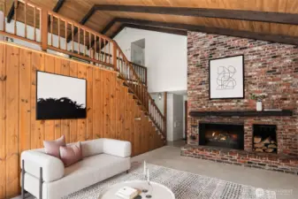 The floor-to-ceiling, extra-large wood-burning fireplace serves as a stunning focal point, adding warmth, character, and a touch of rustic elegance to the space.