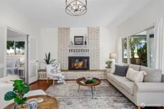 Comfort meets character in this living room, where natural light, soft textures, and a crackling fire create the perfect atmosphere for unwinding.