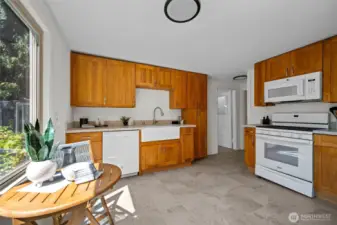 The heart of the home- this warm and inviting kitchen features a farmhouse sink, ample storage, and plenty of counter space for cooking and gathering.