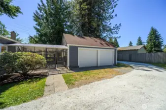 Spacious detached two-car garage with additional shop space, plus a covered breezeway for year-round convenience and easy access to the home.