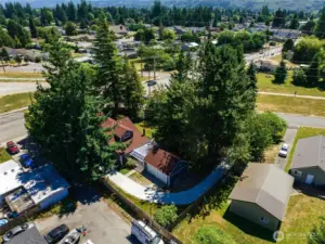 This nearly half-acre property offers lush surroundings, privacy, a circular driveway, and room to grow.