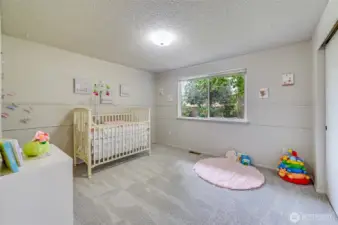 As we head down the hallway, on the Left (back side of the house) we find the first bedroom. Oversized to say the least. Again, New carpet and fresh paint!