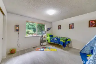 Continuing down the hallway, again on the back side of the house, we come to the second bedroom. New paint and carpet in here too! Very large closet and a nook, where the play tent is at, make this the room everyone calls "dibs" on.