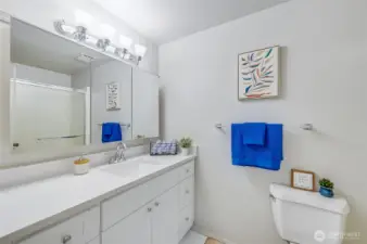 Primary Bathroom. Newly updated with beautiful vanity featuring lots of storage and a sleek quartz countertop. Light and bright and a wonderful way to start your day.
