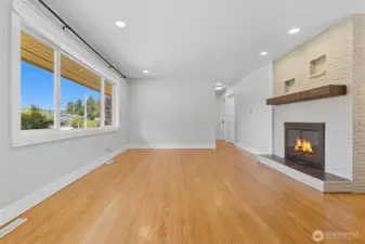 This lovely rambler welcomes you into a bright living area with wood floors, large picture windows and a cozy fireplace.