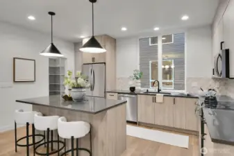 The full size kitchen features an island with seating,