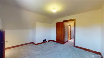 Second of three bedrooms upstairs looking towards doorway
