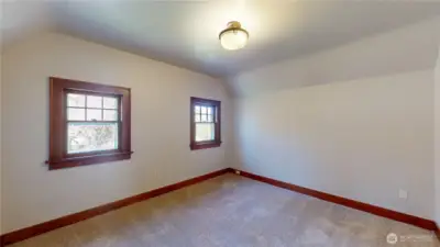 Bedroom number two overlooks that front yare and is very large. This photo is taken from the entry door to the bedroom.
