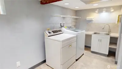 The downstairs laundry room is very large and has a deep sink and counter space for folding or crafts.