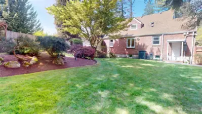 Meticulously maintained backyard of this gorgeous brick tudor home
