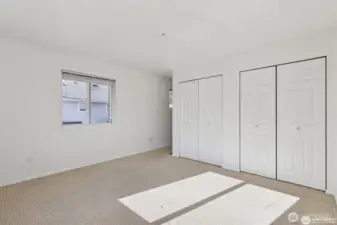 The primary bedroom is spacious with double closets