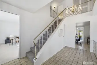 A stunning crystal chandelier serves as a statement piece, adding timeless elegance to the home.