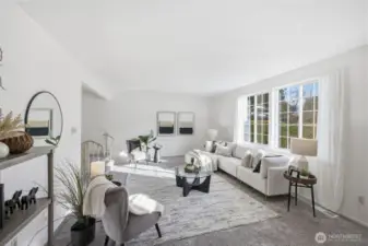 Set slightly below the main level, the sunken living room offers a cozy yet spacious setting ideal for relaxing or entertaining guests.