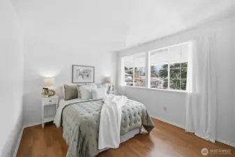 Third bedroom featuring laminated hardwood floors.
