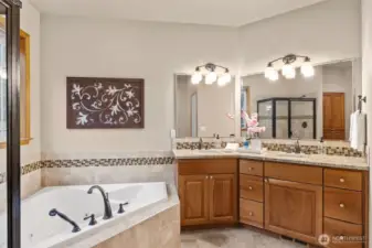 Custom stacked wall cabinetry featuring glass doors to display your treasures, walk in pantry, backyard views, and deck access. Gas cooking with range hood.