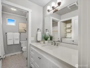 The main full bath is divided for convenient use. The laundry room is also in this space.