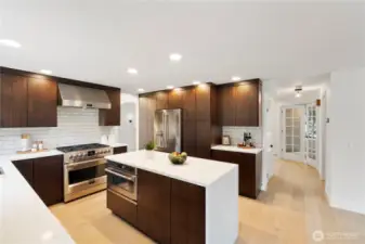 high-end gas range with a stylish hood fan and complemented by a full tile backsplash