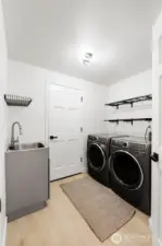 Laundry/Mud room with newer utility sink. Newer Washer/Dryer stay.