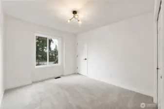 Second bedroom has door which leads to large storage room above garage.