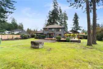 Level, fully fenced yard with mature landscape.