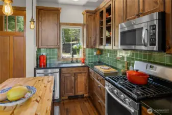 Custom tile backsplash, cabinets and butcher block island!