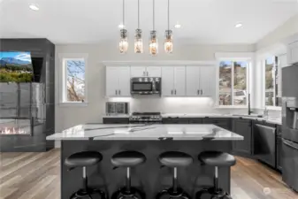 This kitchen is terrific for entertaining! Guests can join in on food and drink prep, watch TV, enjoy views from every window, play games, and much more!