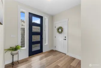 The extra tall door creates a grand entry.  The door with the wreath leads to the garage.