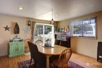 Dining area with glass sliding doors to the deck and yard