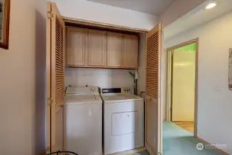 Laundry closet with storage cabinets