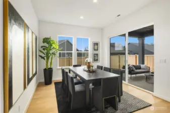 Spacious dining room off the kitchen opens up to a covered patio and fully fenced backyard  Photos are for illustrative purposes only.