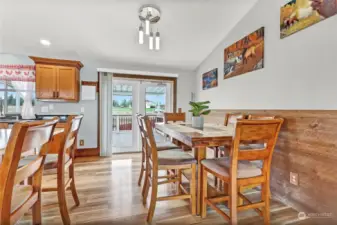 A closer view of the dining room, new lights and view of the upper covered deck.