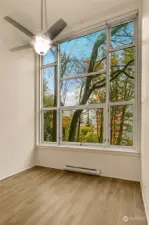 Bathed in radiant natural light from an expansive floor-to-ceiling wall of high-efficiency southwest-facing windows, this one-bedroom loft condominium invites you to revel in an airy, open design with a breathtaking 14-foot ceiling. A unique city treasure, it offers an elevated view over a lush embankment of mature maples, infusing every moment with tranquility. Perched above a quiet street, it feels like a hidden sanctuary, yet places you effortlessly within reach of urban vibrancy. Whether as your personal retreat, a full-time city base, or a coveted rental, this Talisman loft merges sophisticated style, comfort, and an irresistible touch of nature—your own urban haven.