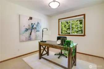 Versatile main floor retreat or den with a sleek 3/4 bath nearby.