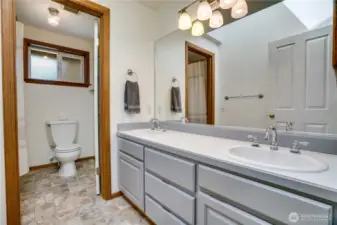 Upstairs full bath with dual vanity.