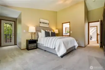 Opulent primary suite with a private balcony, vaulted ceilings and serene elegance.