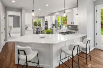 Chef's kitchen with premium stainless steel appliances, wine refrigerator, walk-in pantry, breakfast nook and abundant prep space.