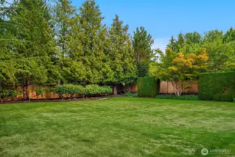 Mature trees provide natural privacy, while the lush, level lawn creates plenty of space to play, entertain, or simply unwind in your own private retreat.