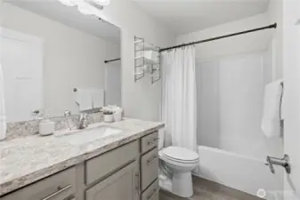 Primary bath with granite countertops and undermount sink.