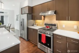 Gas stove includes a center griddle burner.