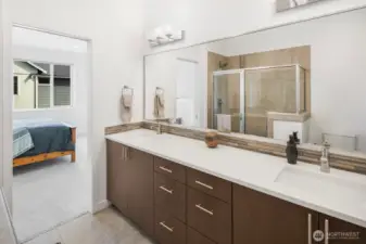Full-size mirror and lots of light in this large private primary suite bathroom.