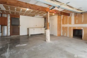 The spacious 2 car attached garage has a man door off the back as well as interior access to the ADU stairwell on the right.