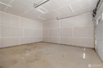 Huge heated garage with high ceilings and shop space.