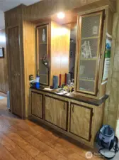 Wet bar, storage cabinets and coat closet off family room