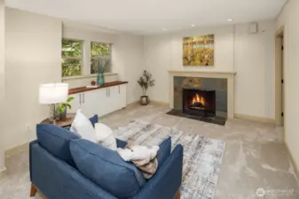 Basement living room with the last of the four fireplaces. Plenty of light in here!