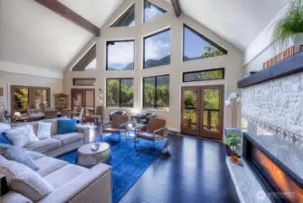 Main lodge boasts soaring ceilings, multiple access points to expansive decks, and a breathtaking wall of windows that perfectly frame the mountain views.