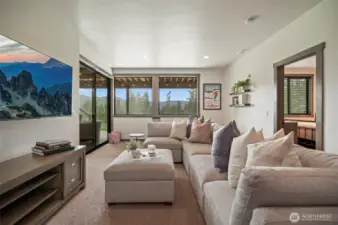 Head downstairs and you find another gathering area that leads out to a covered patio and a few steps from the hot tub - anyone want a soak?