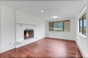 Family room with wood burning fireplace.
