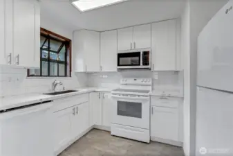 Remodeled kitchen with quartz counter top.