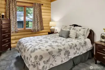 Primary bedroom shows off yellow cedar logs